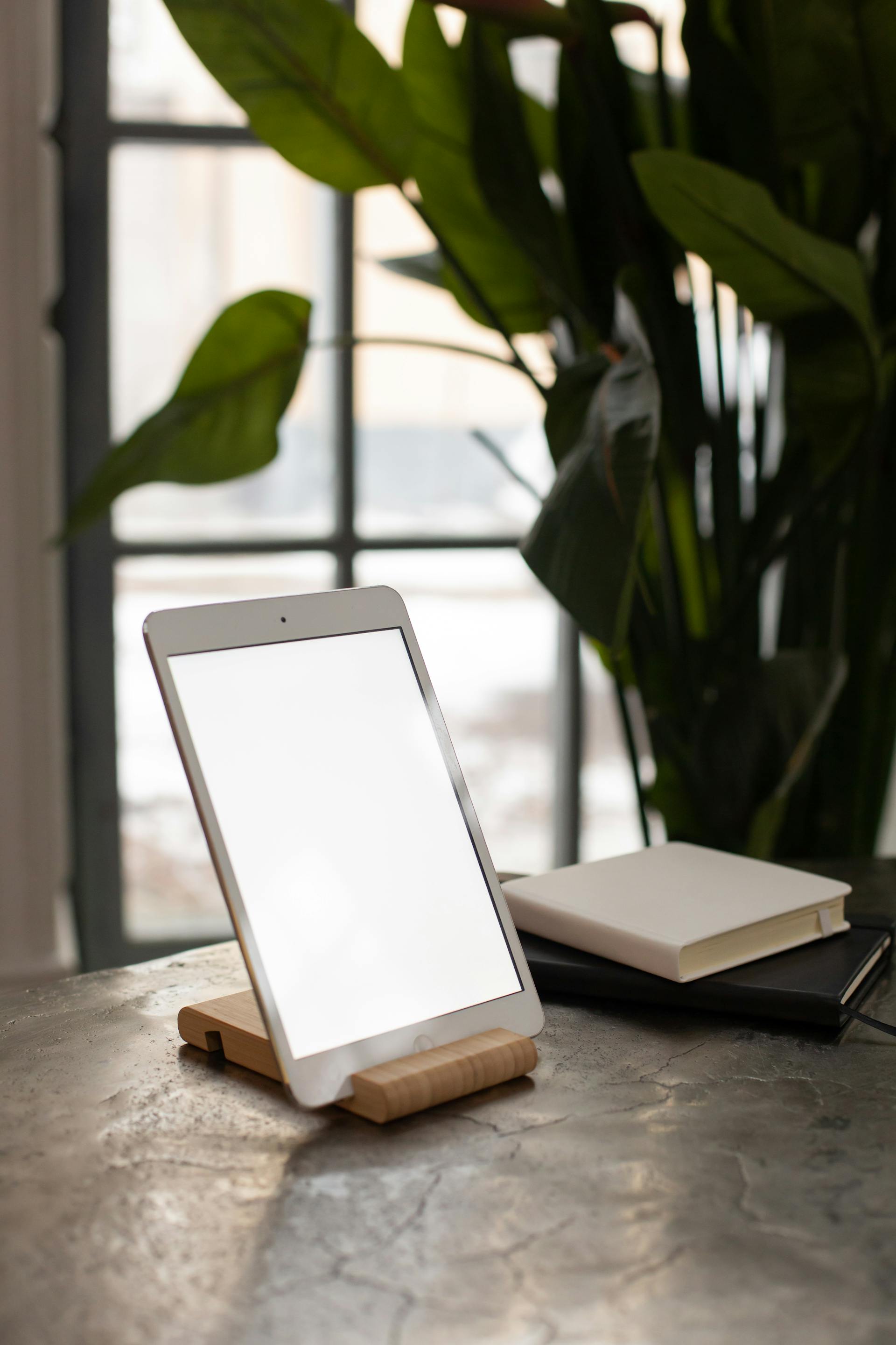 A tablet showing the daily shiur beside an open sefer